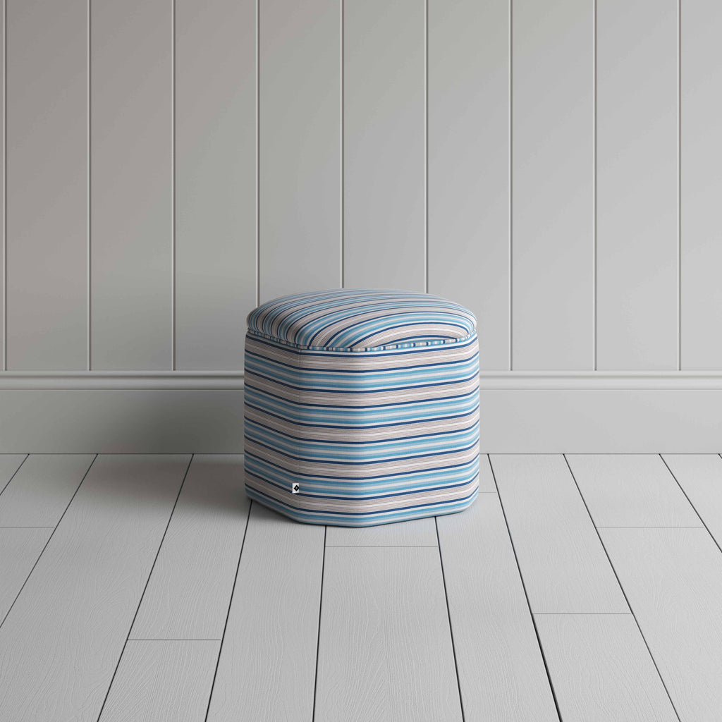 Small ottoman with blue and white stripes, ideal for a stylish and cozy seating option.