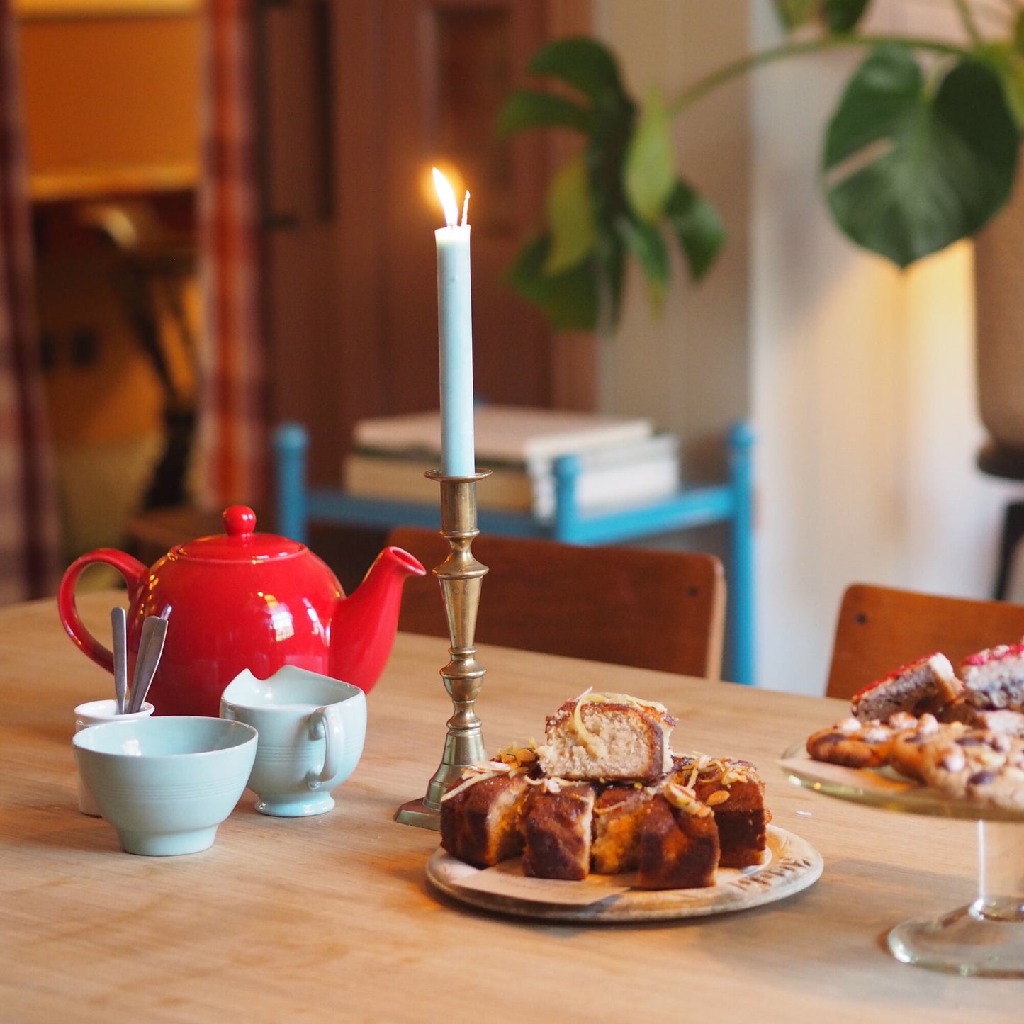 Candle, Tea pot, with cups and pie on the dining table - NiX