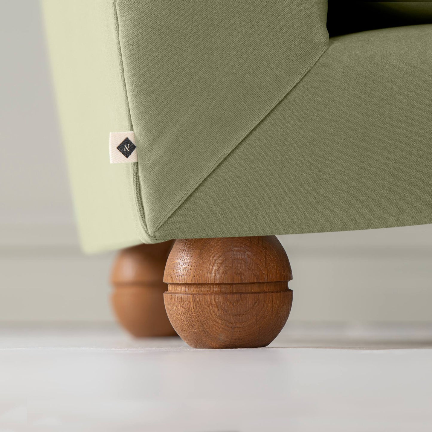 Perch Slipper Armchair in Intelligent Velvet Green Tea. Back Round Wooden Foot Closeup With NiX Special tag