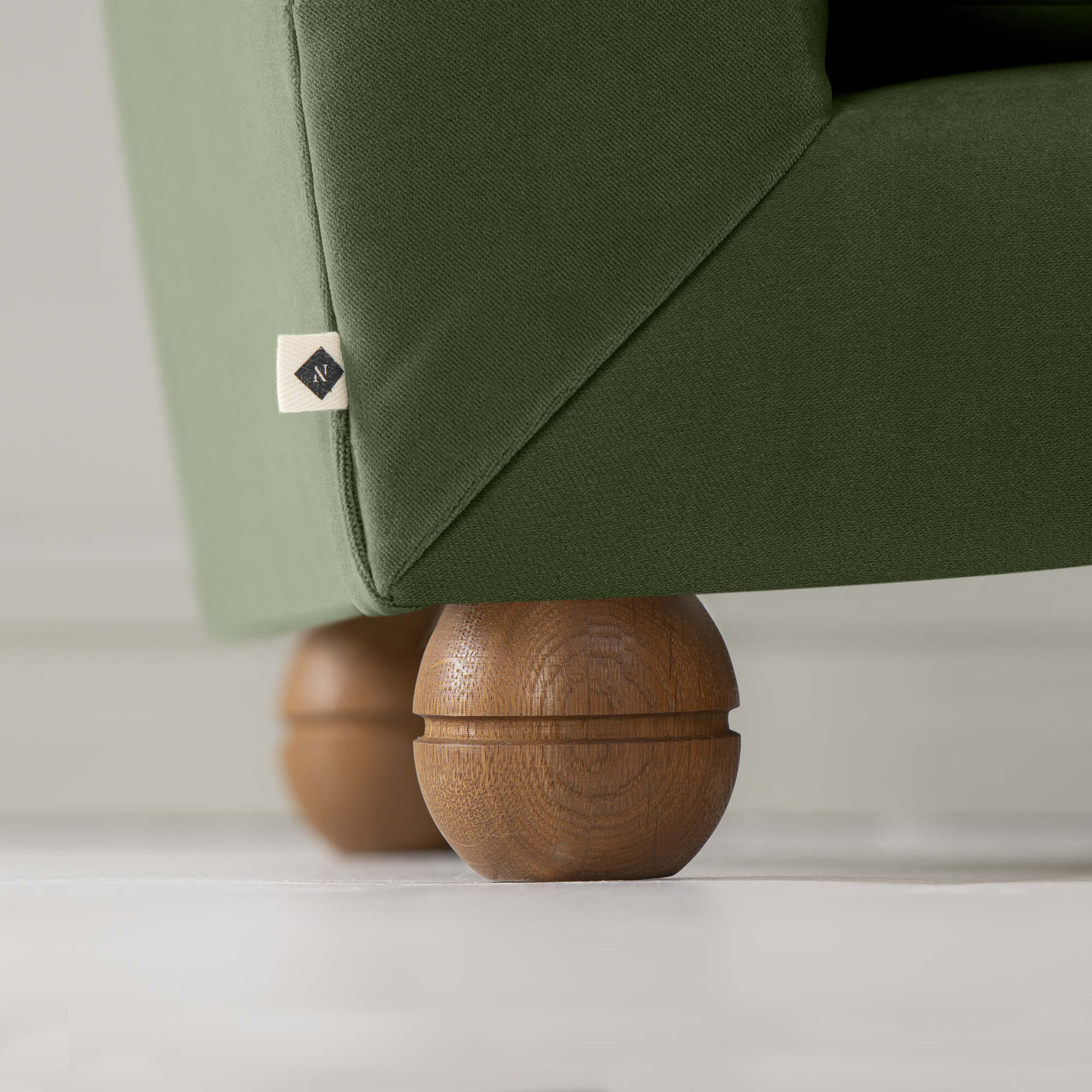 Perch Slipper Armchair in Intelligent Velvet Juniper, Back Side Round Wooden Foot Closeup With NiX Special Tag