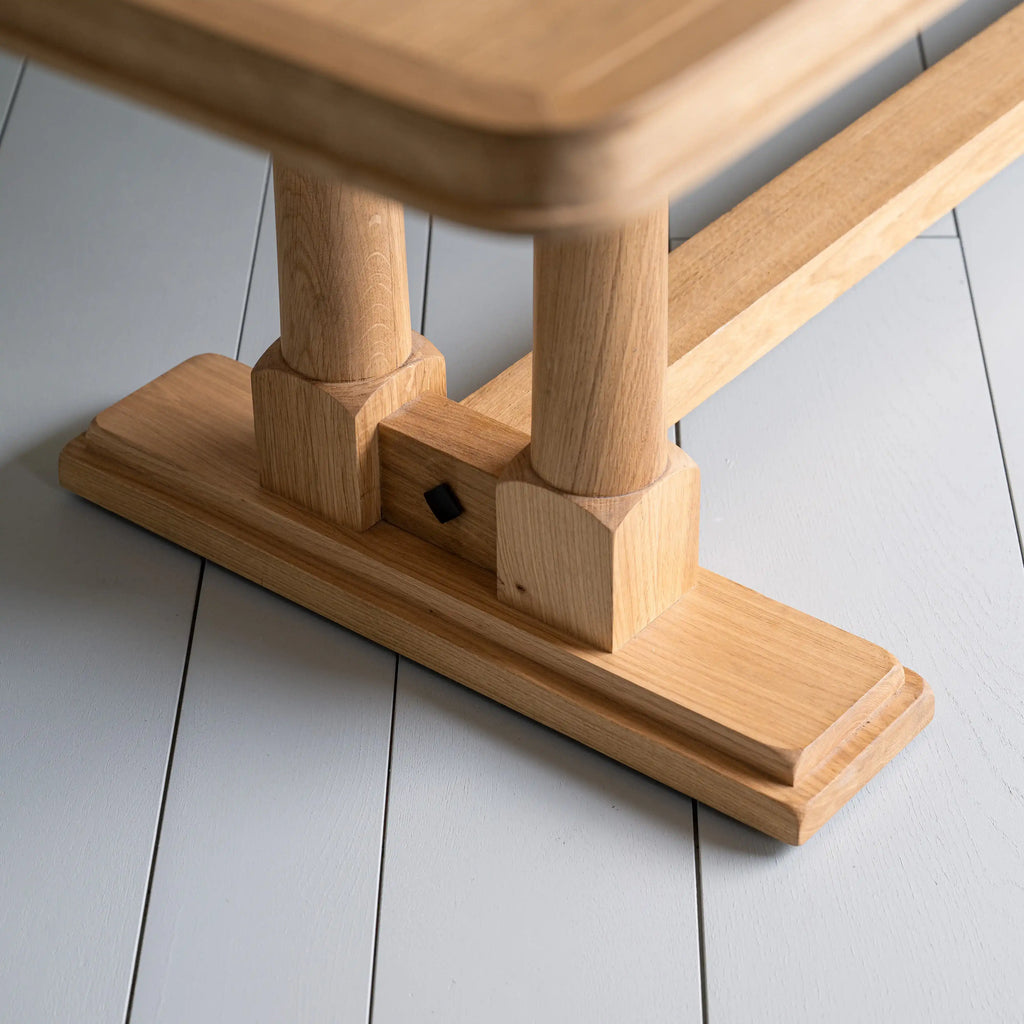 Tuck In rectangular dining table in oak with strong foot design, manufactured by NiX by Nicola Harding & Co.