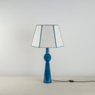 Comet Ceramic Table Lamp Base in Blue, With Townhouse Hexagonal Lamp Shade in Soft White with Peacock Blue Trim & Stitching - Nicola Harding