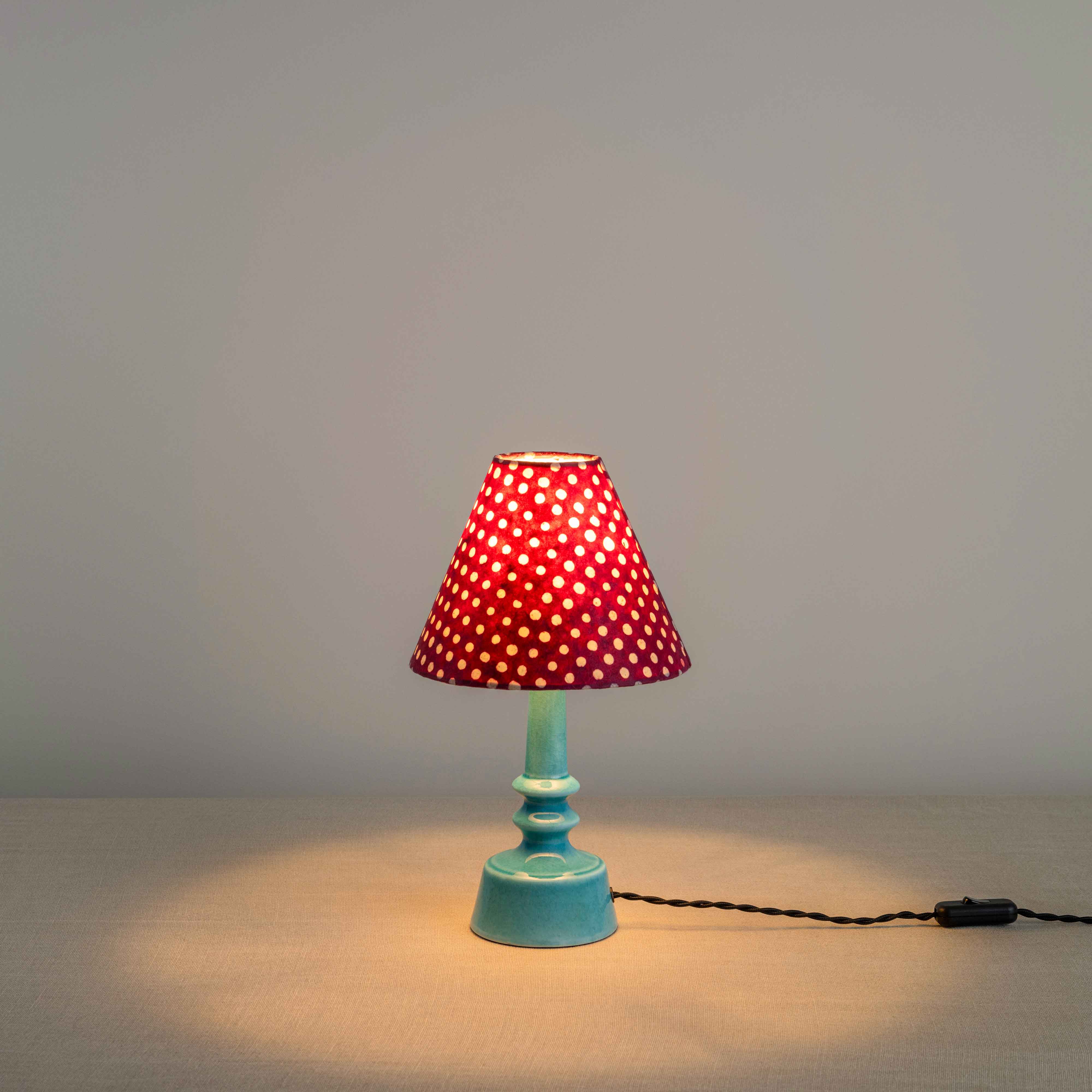 Ditsy Ceramic Table Lamp Base in Turquoise, With Ditsy Classic Empire Lamp Shade in Dotty Maroon, With Lights 'ON' - Nicola Harding