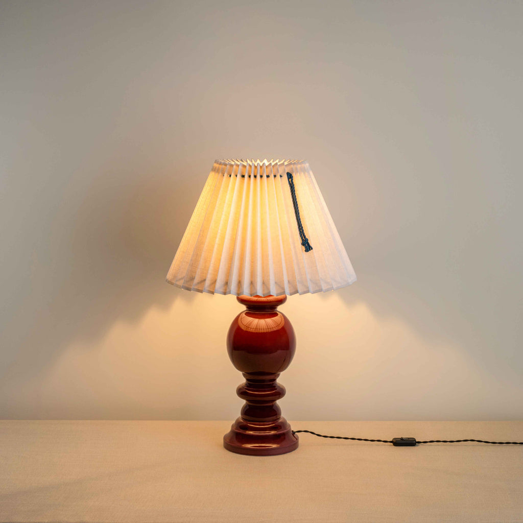 Hourglass Ceramic Table Lamp Base in Cherry, With Sunburst Concertina Natural Pleat Lamp Shade with Mauve Cord With Lights 'ON' - Nicola Harding