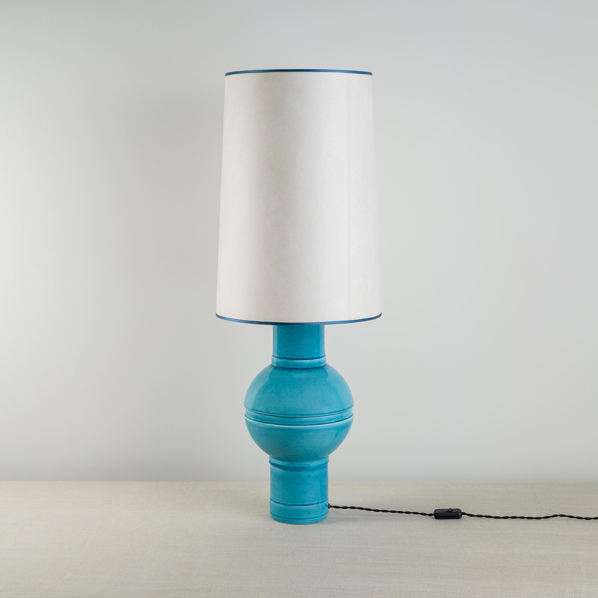Orb Ceramic Table Lamp Base in Turquoise, With Whimsical Tall Straight Empire Lamp Shade in Soft White with Peacock Blue Trim - Nicola Harding
