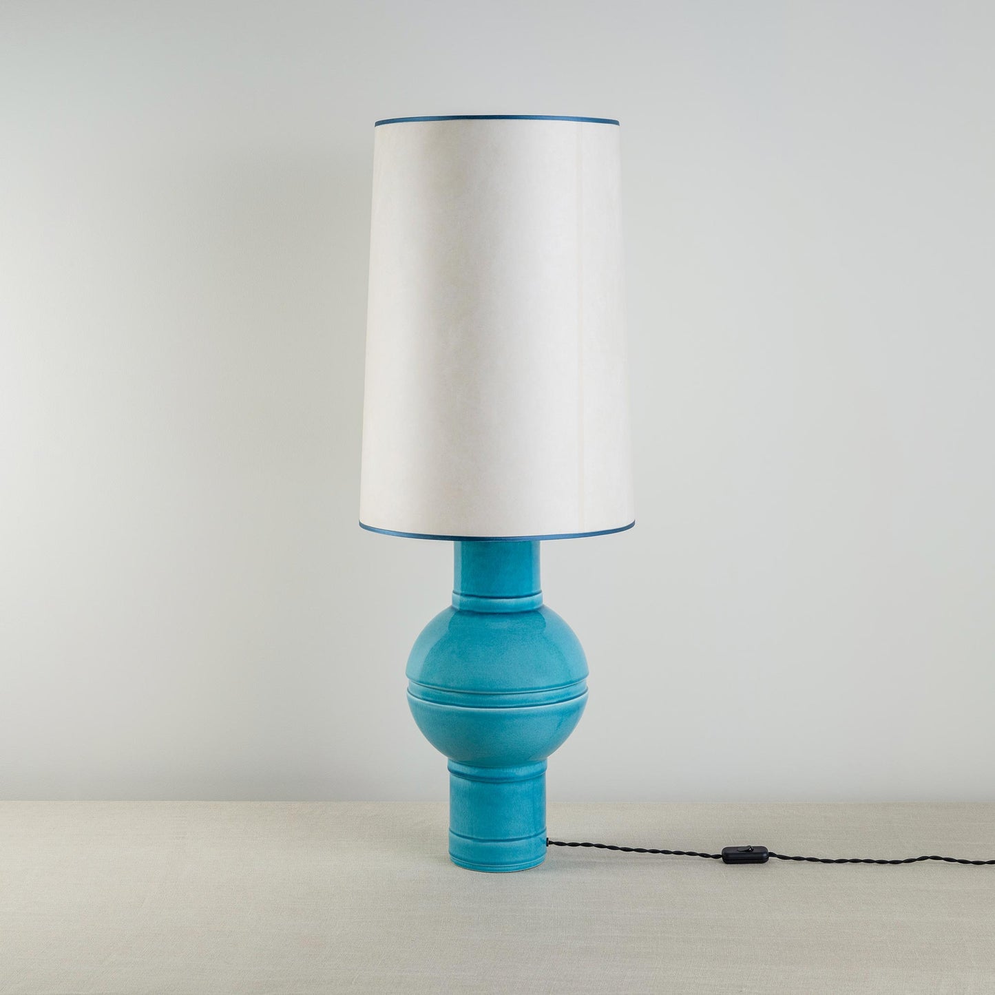 Orb Ceramic Table Lamp Base in Turquoise, With Whimsical Tall Straight Empire Lamp Shade in Soft White with Peacock Blue Trim - Nicola Harding
