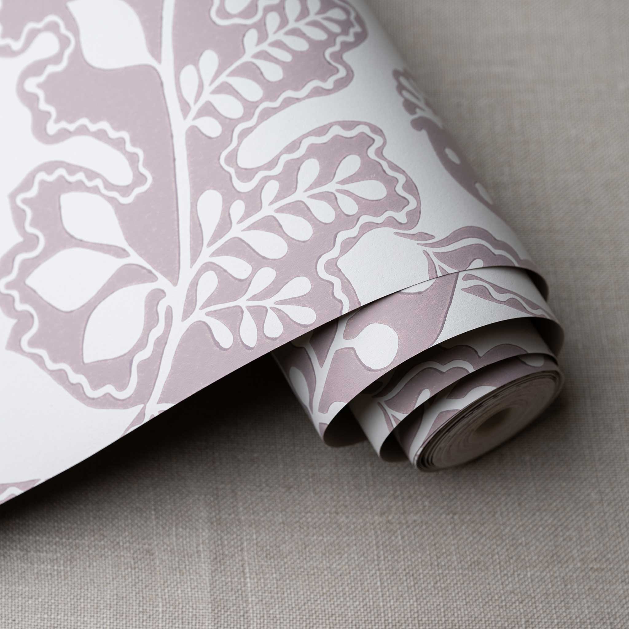 Albion Wallpaper in Mauve, shown as a roll, designed by Nicola Harding & Co.