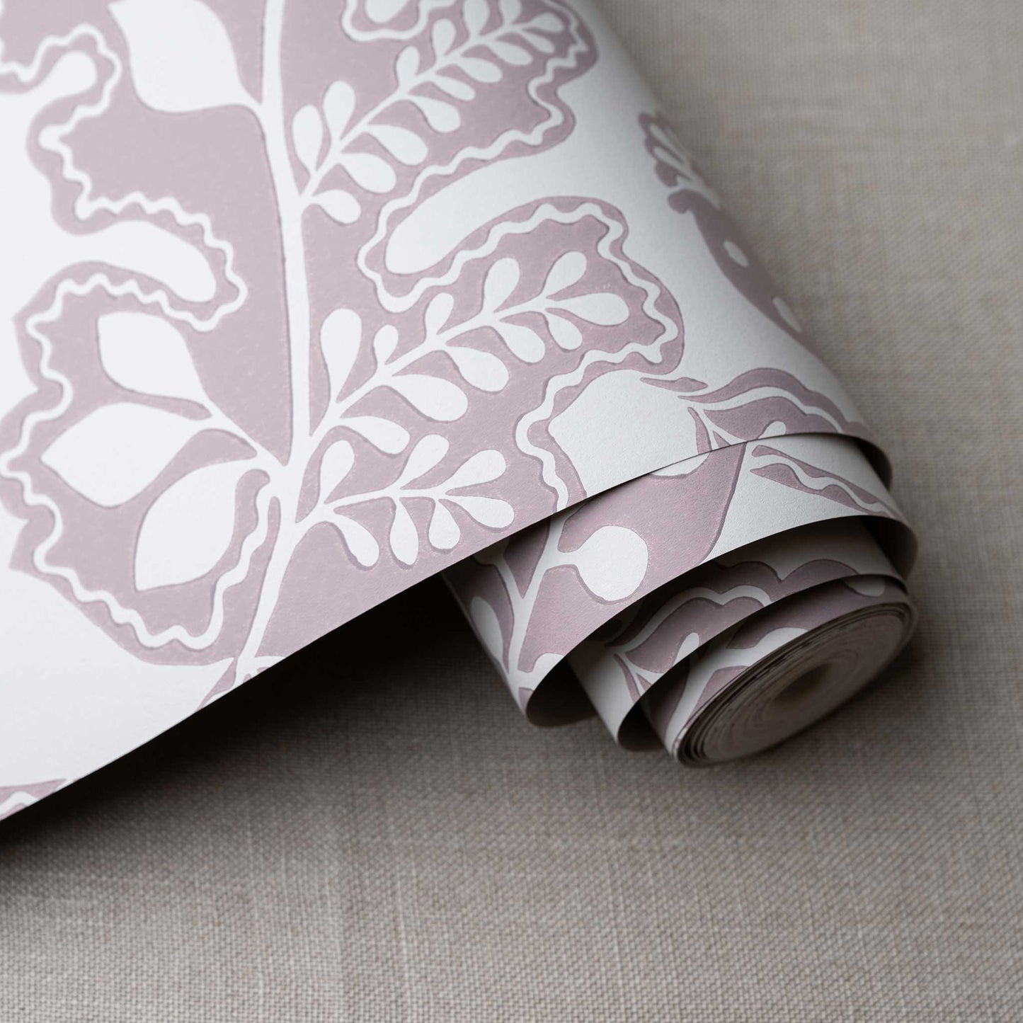 Albion Wallpaper in Mauve, shown as a roll, designed by Nicola Harding & Co.