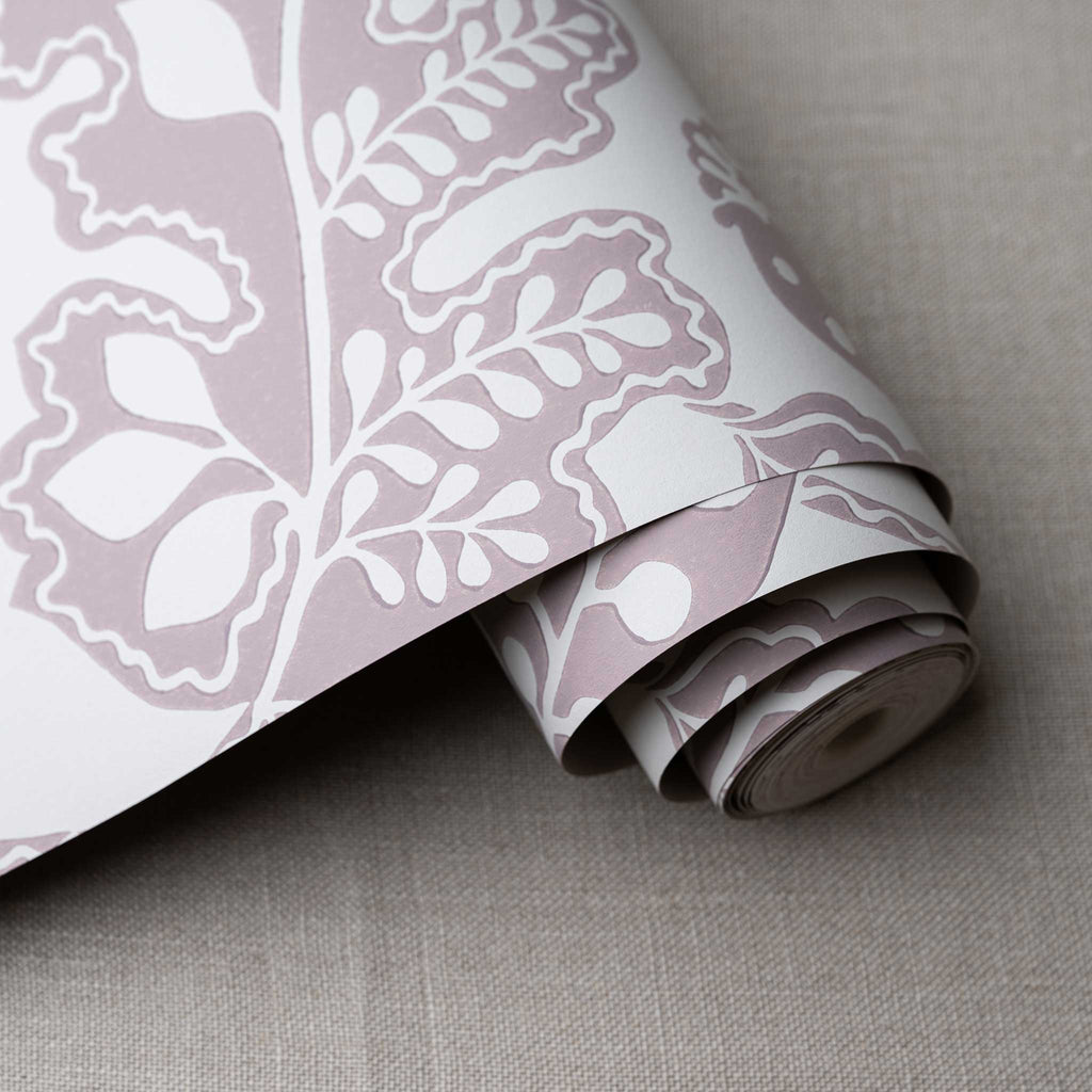 Albion Wallpaper in Mauve, shown as a roll, designed by Nicola Harding & Co.