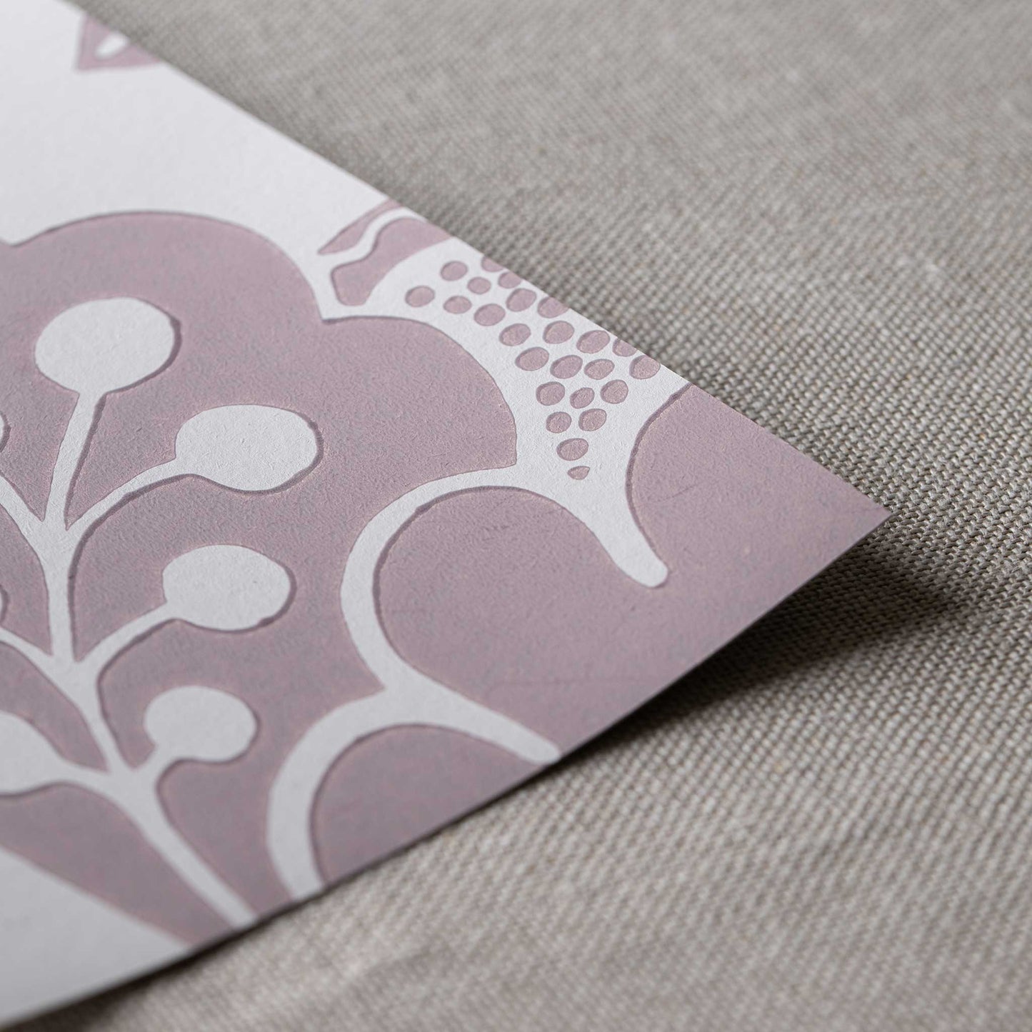 Close-up of the fine, neat edge of Albion Wallpaper in Mauve, designed by Nicola Harding.