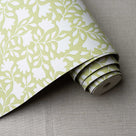 Ginkgo wallpaper in Moss Green, shown as a roll, designed by Nicola Harding.