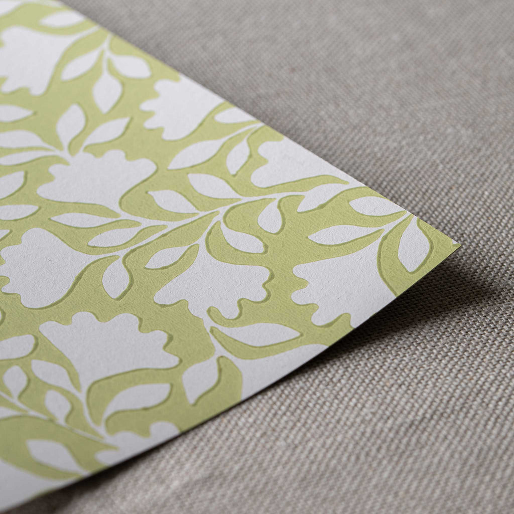 Close-up of the fine, neat edge of Ginkgo wallpaper in Moss Green, designed by Nicola Harding.