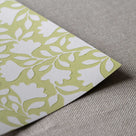 Close-up of the fine, neat edge of Ginkgo wallpaper in Moss Green, designed by Nicola Harding.