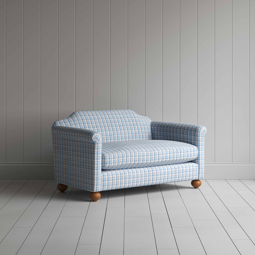 A close-up of a blue and white checkered sofa, showcasing its intricate pattern and inviting texture.