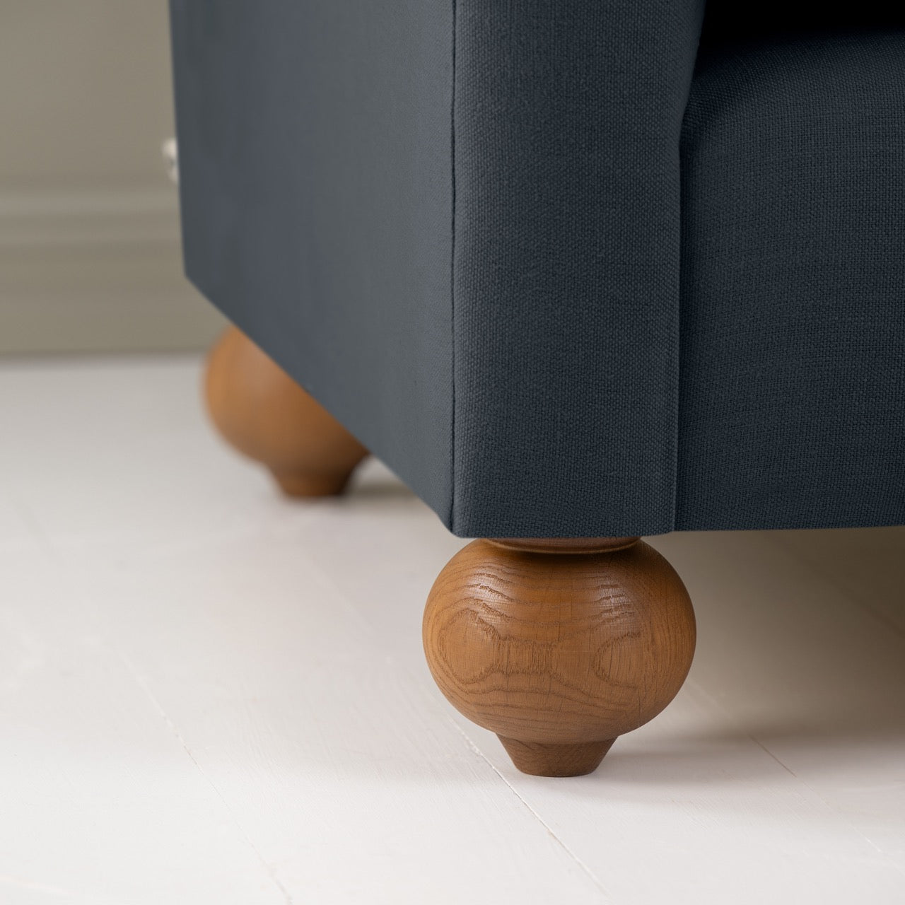  Dolittle 2 Seater Sofa in Laidback Linen Midnight, Round Wooden Foot Closeup - Nicola Harding 