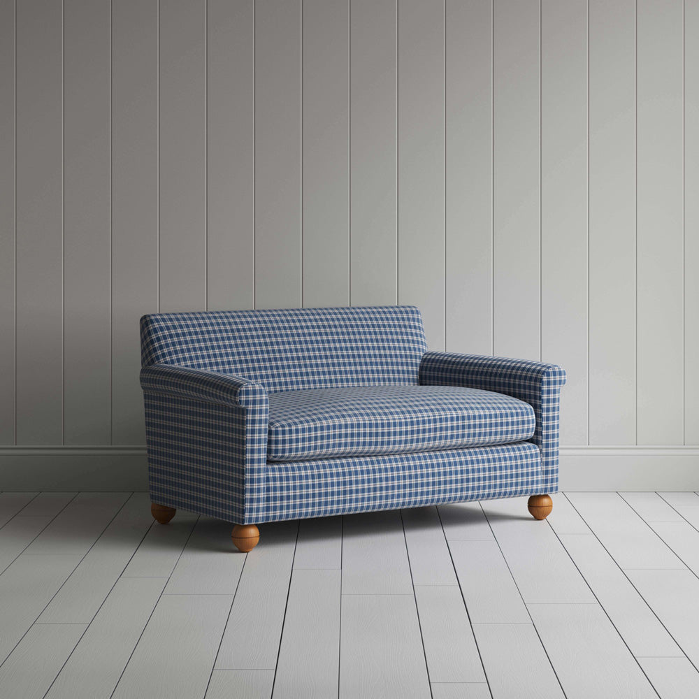 Stylish blue and white checkered sofa in a well-decorated room.