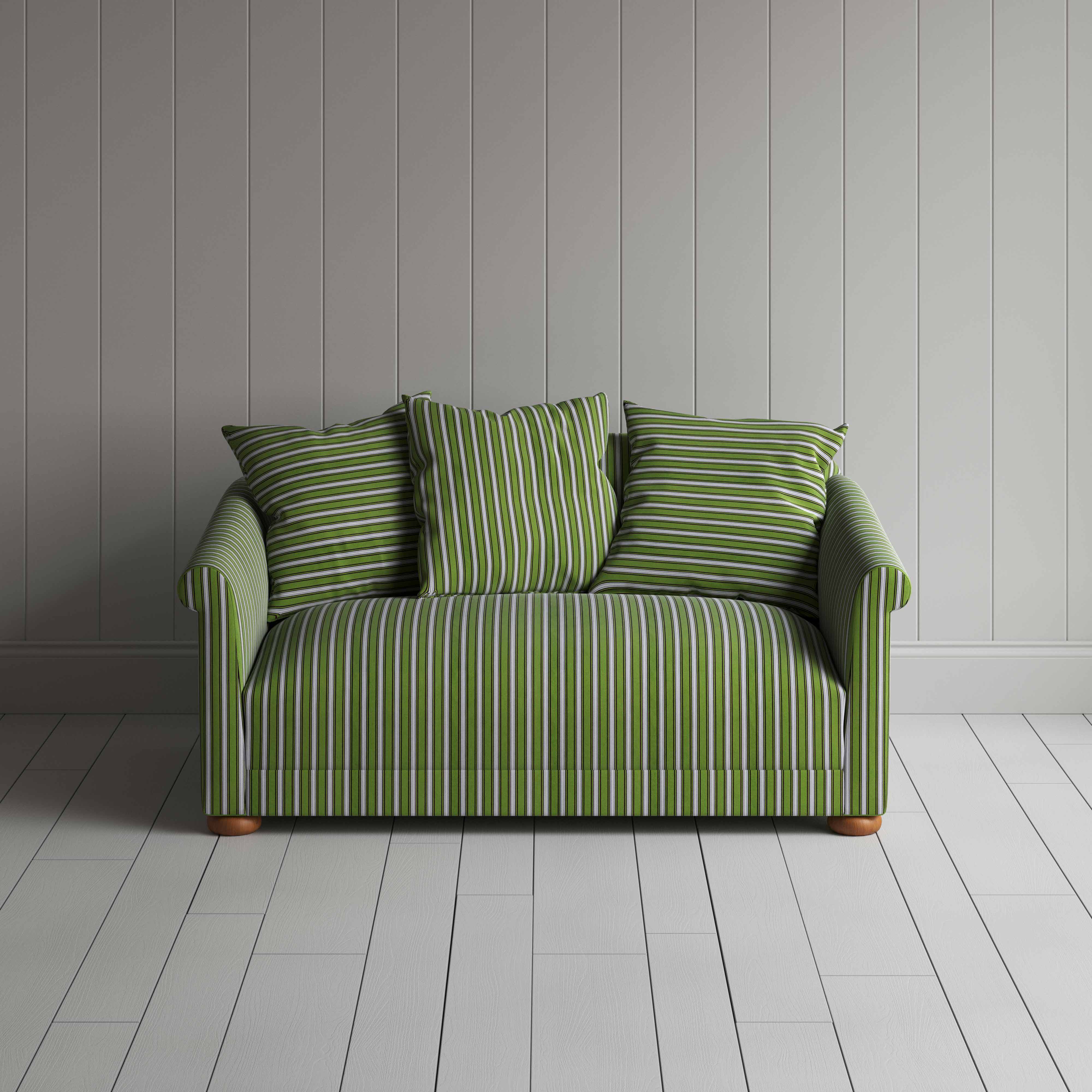  Detailed view of a green and white striped sofa. 