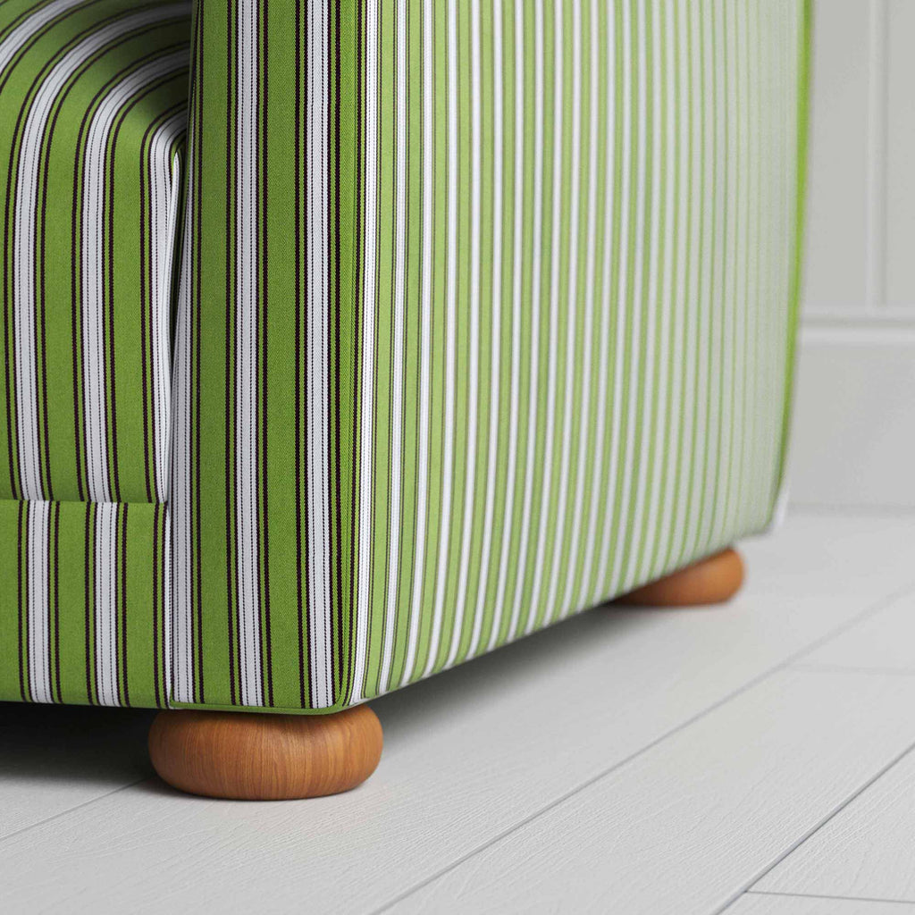  A close-up of a green and white striped sofa, adding a touch of elegance and vibrancy to any room. 