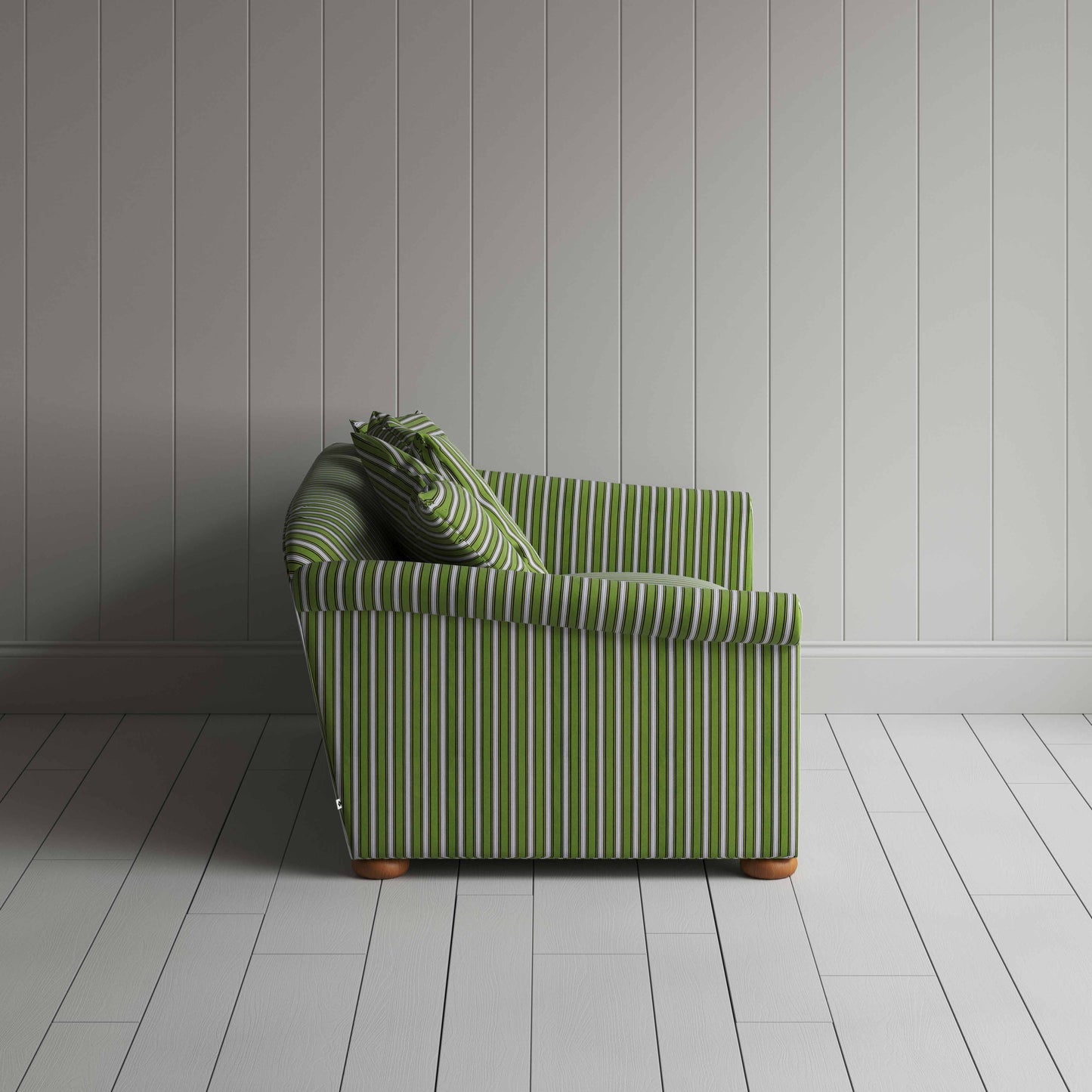 Striped green and white sofa in front of wall.