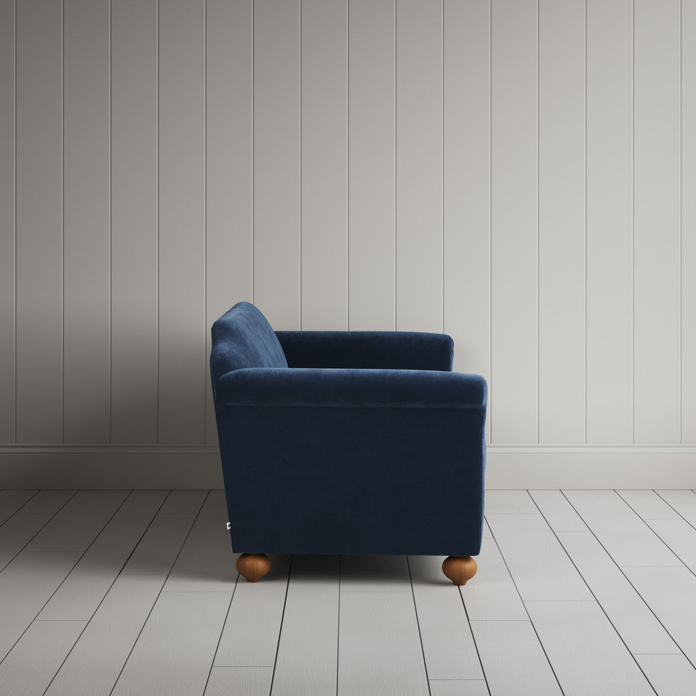  Side profile of the dark blue corduroy Dolittle sofa 