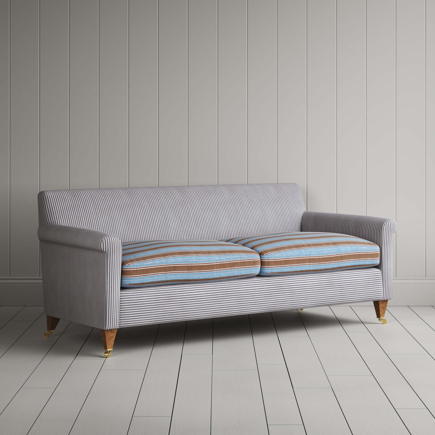 Angled view of the Ticking Blue Brown Idler sofa by NiX