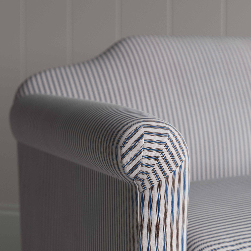  A close-up of a striped fabric sofa. 