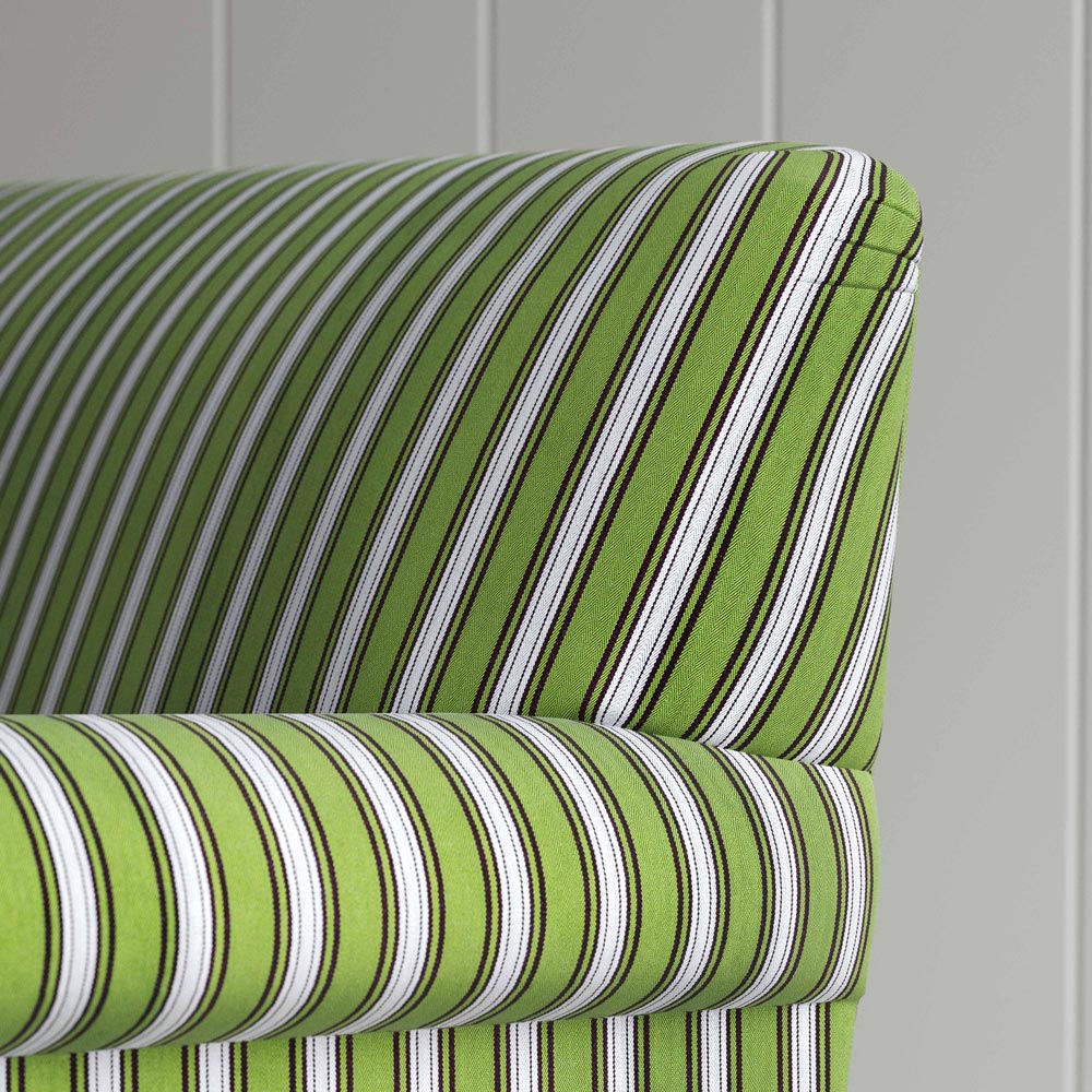 A close-up of a green and white striped chair, adding a touch of elegance and vibrancy to any room.