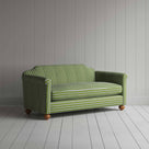  Striped green and white sofa by a wall. 