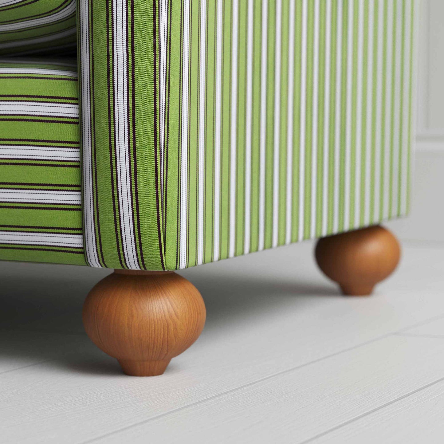 A close-up of a green and white striped sofa