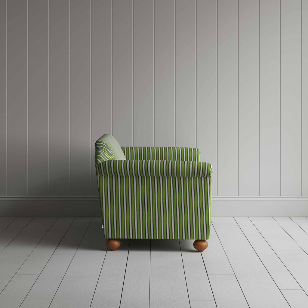  Striped green and white sofa next to a wall. 