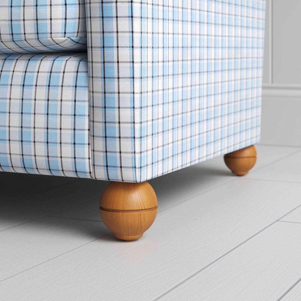  A close-up of a blue and white checkered sofa, showcasing its intricate pattern and inviting texture. 