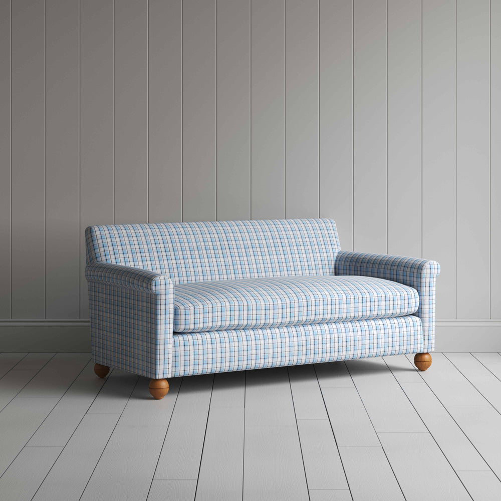 Stylish blue and white checkered sofa in a well-decorated room.