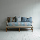  White couch on wooden floor in minimalist living room. 