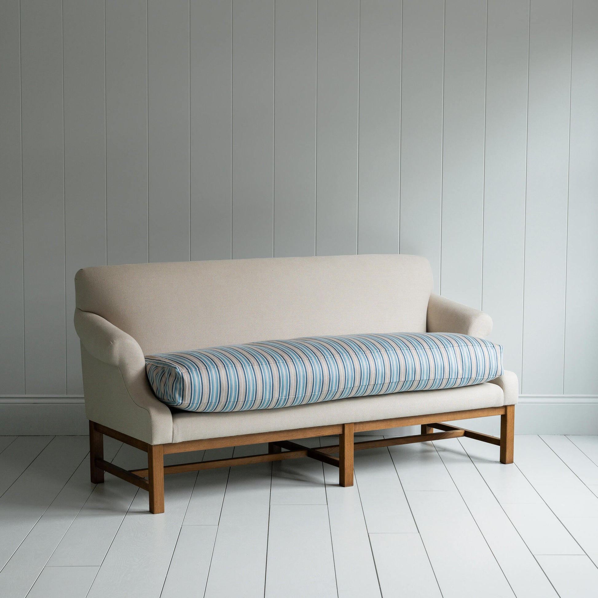 White couch on wooden floor in minimalist living room.