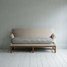  White couch on wooden floor in minimalist living room. 