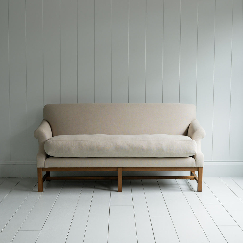  White couch on wooden floor in minimalist living room. 