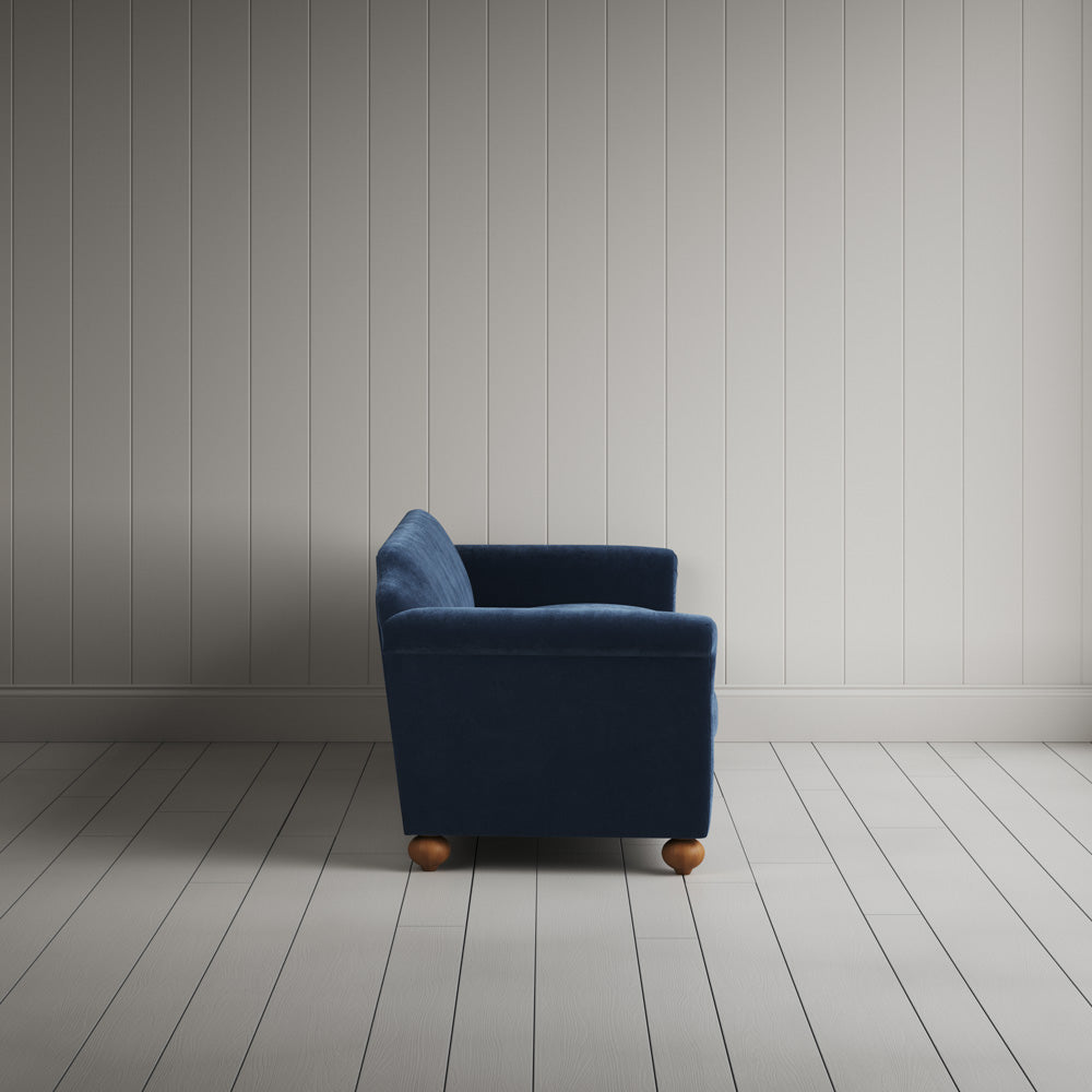  Side profile of the dark blue corduroy Dolittle sofa 