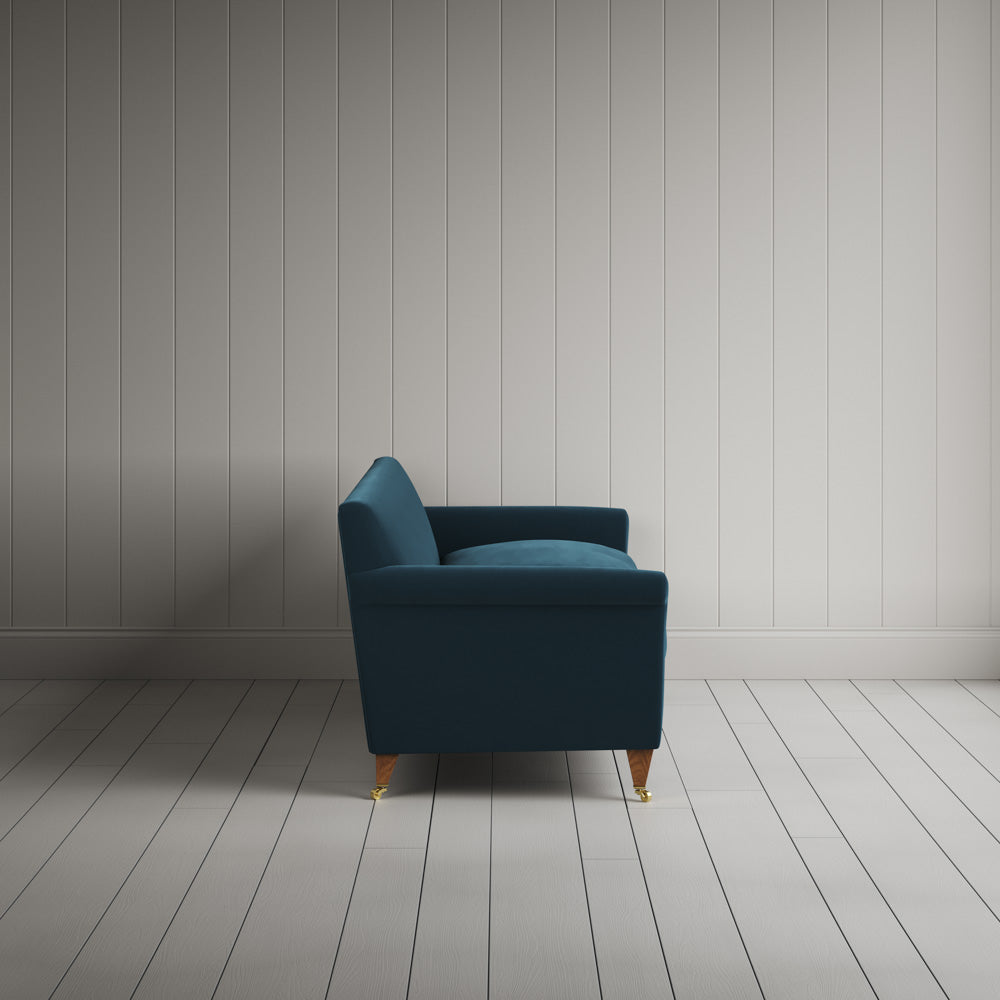 Side profile of the Velvet Aegean Idler sofa by Nicola Harding