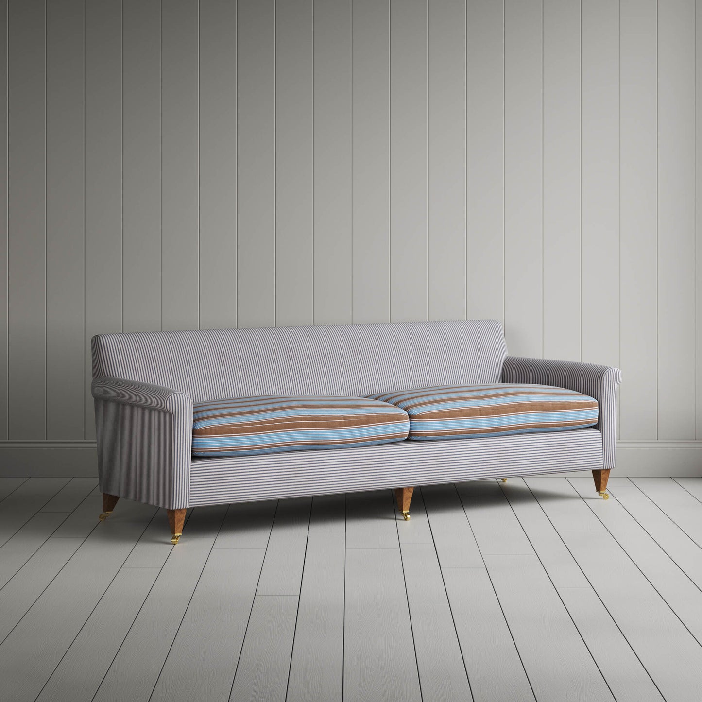 Angled view of the Ticking Blue Brown Idler sofa by NiX