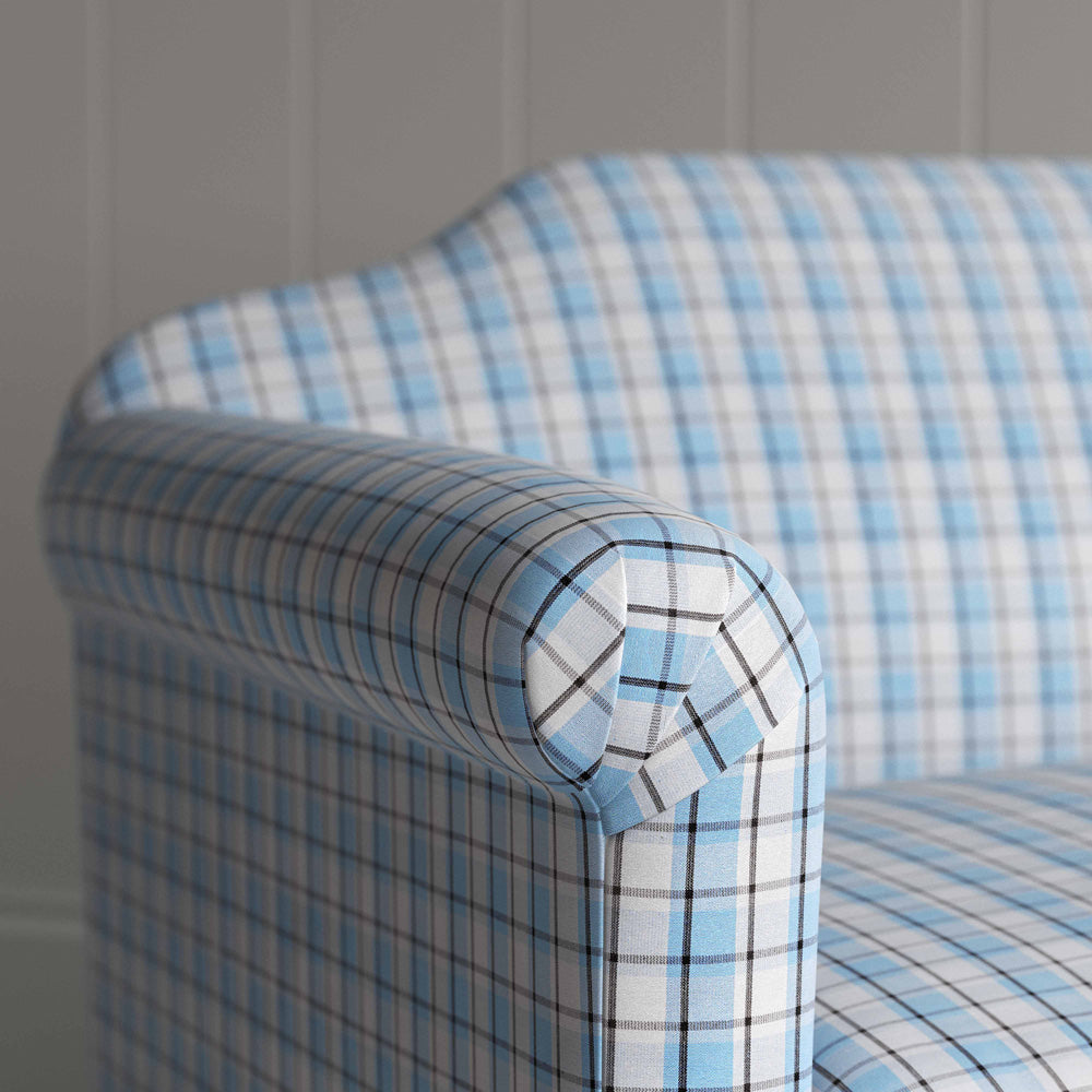  A close-up of a blue and white checkered sofa, showcasing its intricate pattern and inviting texture. 