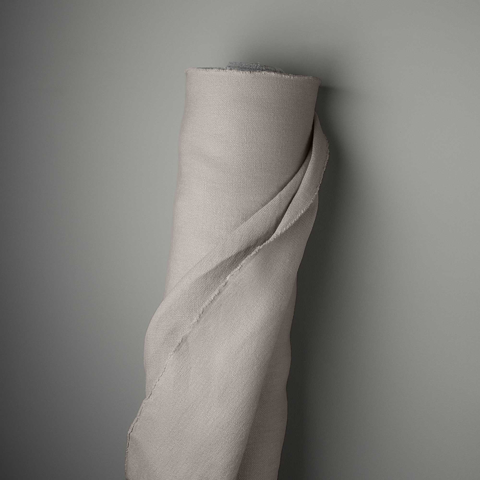  A rolled up piece of fabric hanging on a wall. 