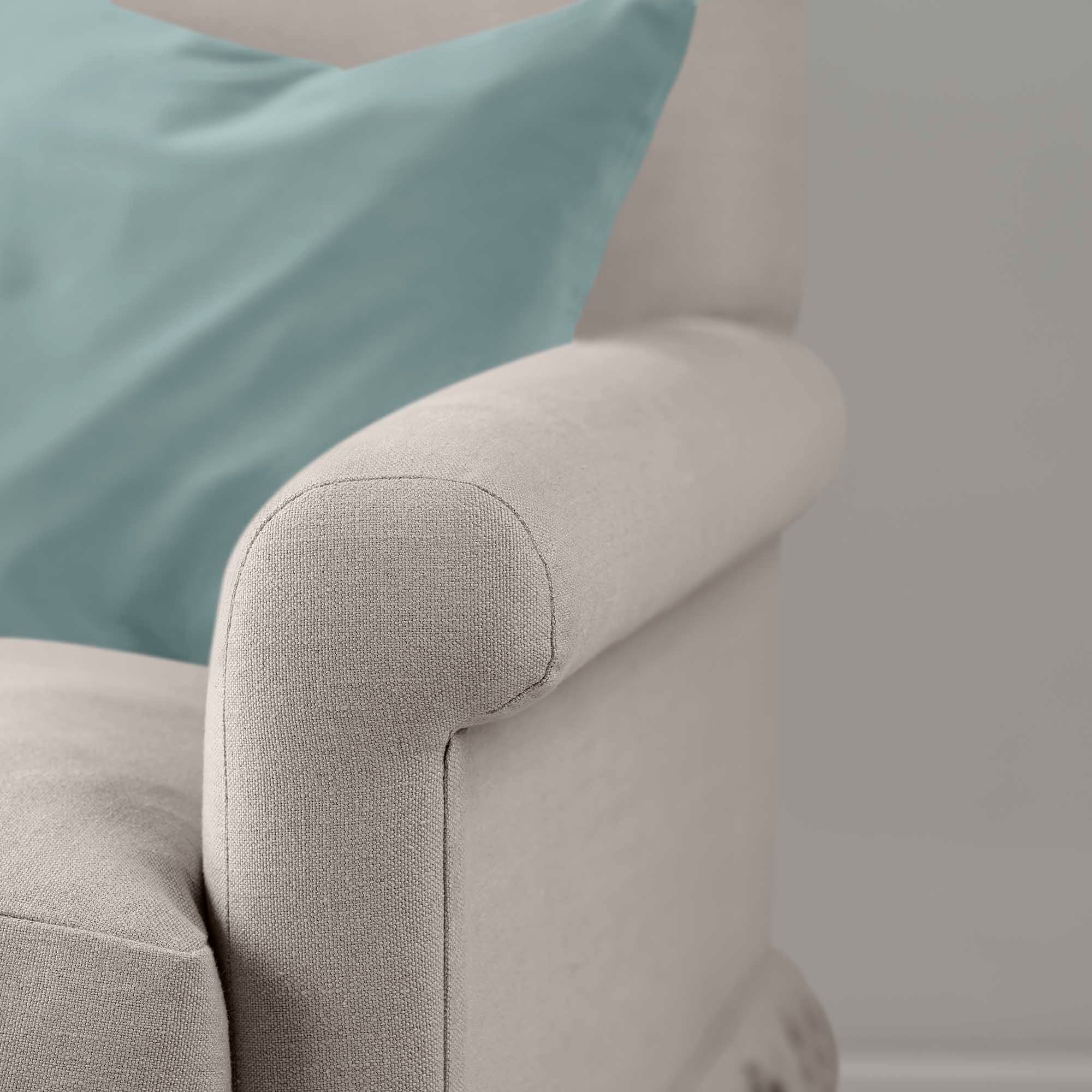  A detailed image of a light blue pillow on a sofa. 