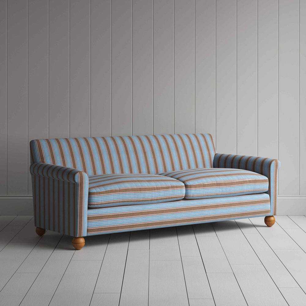 Striped blue and white sofa on wood flooring.