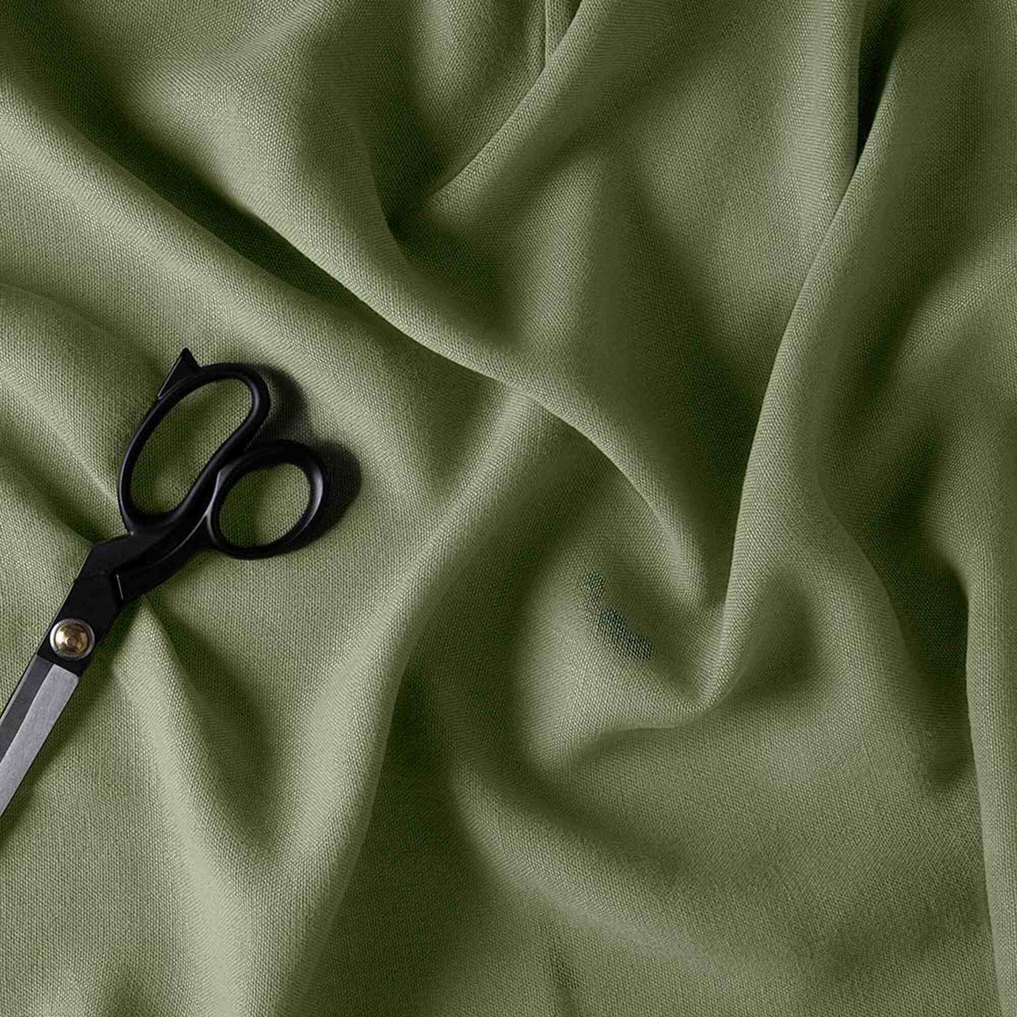  Green fabric with scissors. 