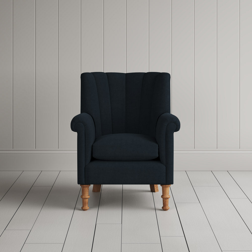 Time Out Armchair fluted back design in laidback linen midnight, front view by Nicola Harding.