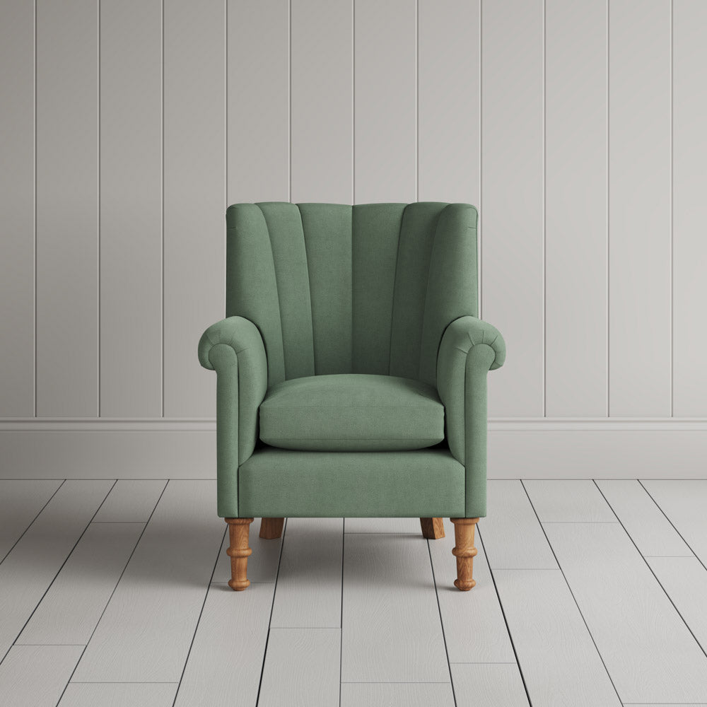 Time Out Armchair fluted back design in laidback linen moss, front view by Nicola Harding.