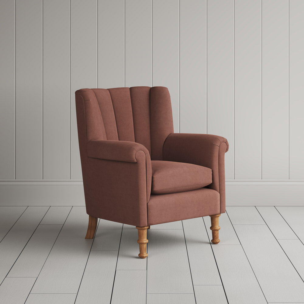  Nicola Harding interiors compact upholstered linen wingback armchair, angled studio view. 
