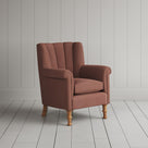 Nicola Harding interiors compact upholstered linen wingback armchair, angled studio view.