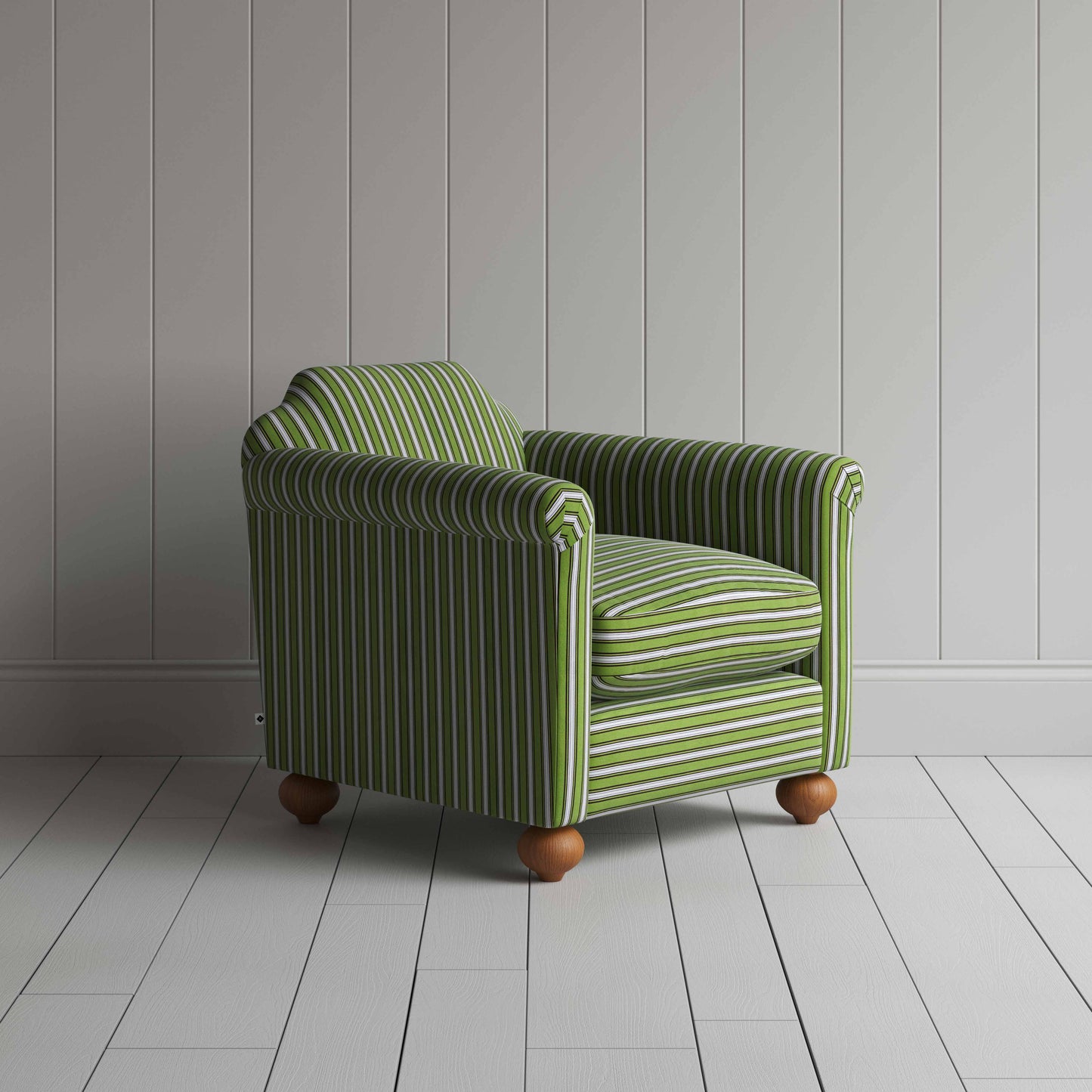 A green and white striped chair on a wooden floor, adding a touch of elegance to the room's decor.