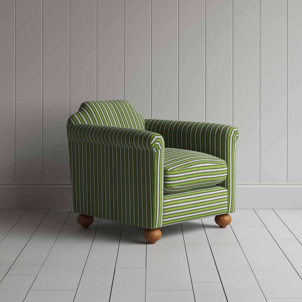  A green and white striped chair on a wooden floor, adding a touch of elegance to the room's decor. 